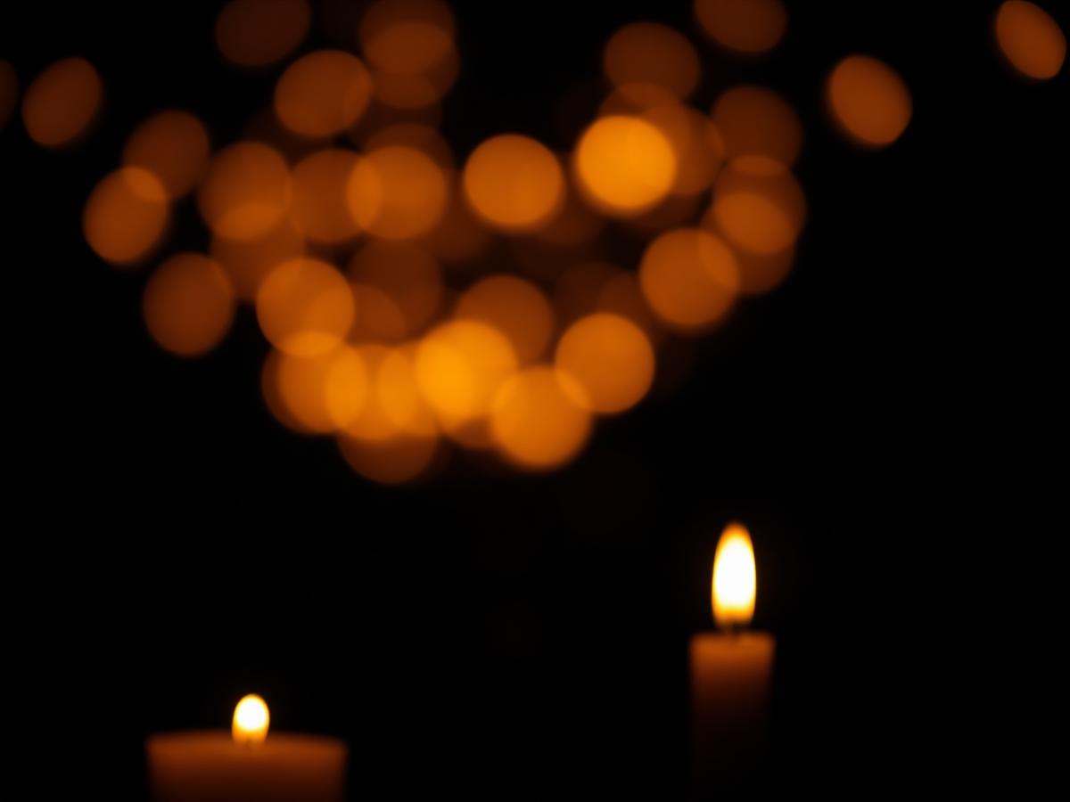 Candles glowing softly in darkness